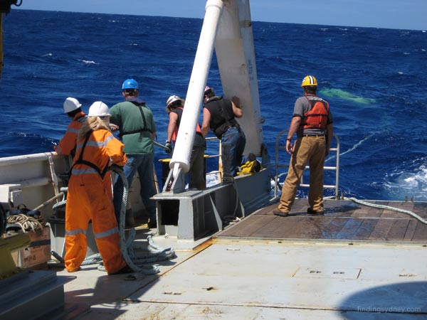 Crew hauling the SM30 sonar towfish back towards the vessel.